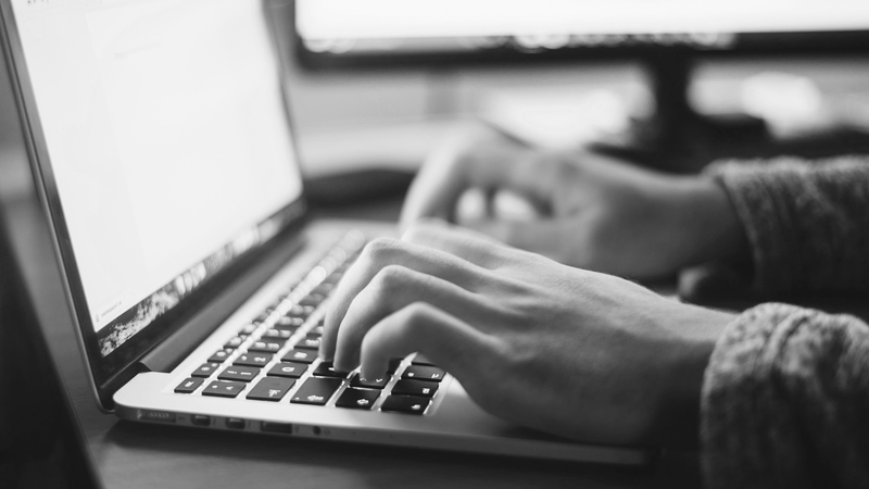 Hands typing on a laptop keyboard – symbolizing digital work and modern communication.